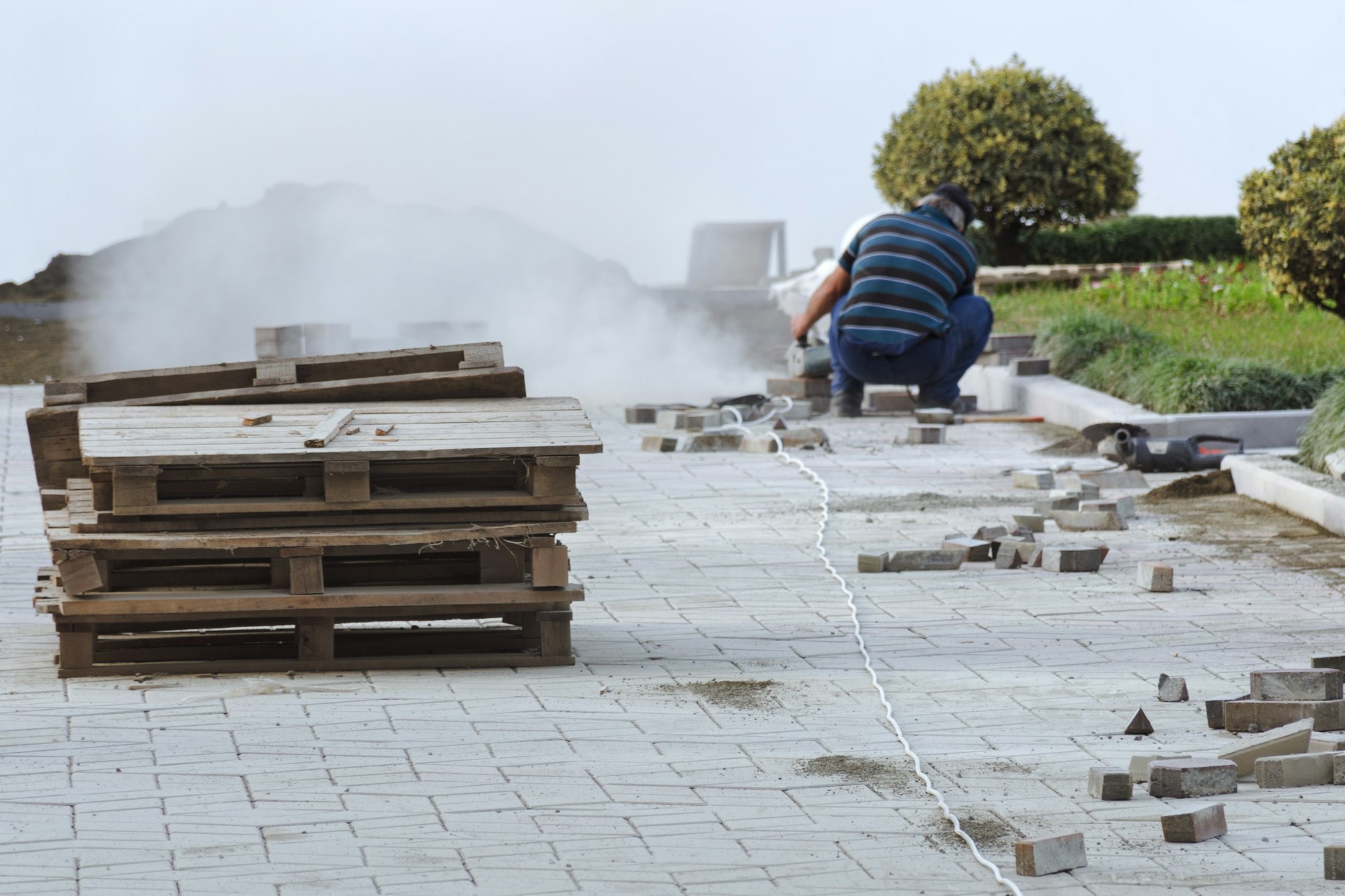 Working laying of paving slabs.